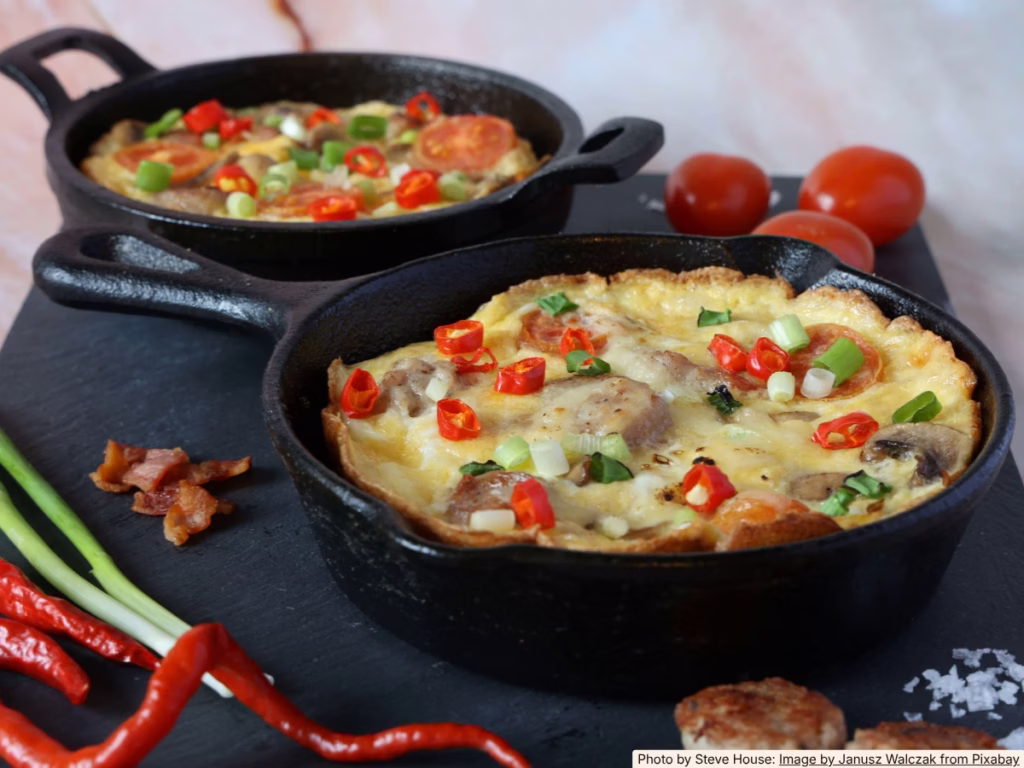 Rustic egg frittata in a cast iron skillet on a home kitchen counter, made from leftover vegetables