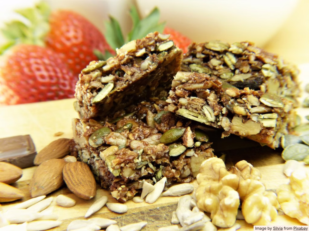 Homemade granola bars cooling on a wire rack on a bright kitchen counter